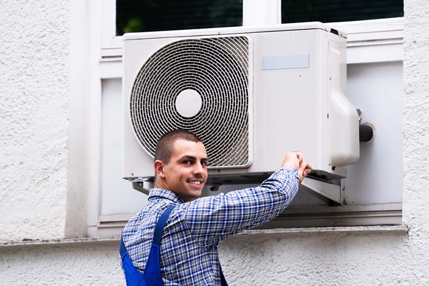 Technician installing AC