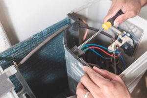 technician dismantles AC unit