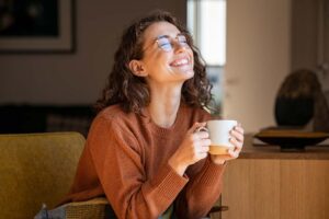 woman holding a cup of hot coffee