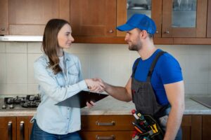 plumber and homeowner talking